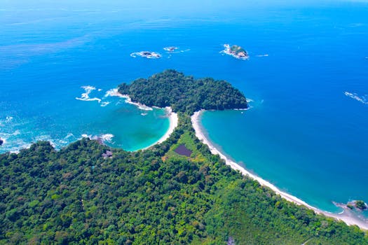 Stunning aerial shot of the lush coastline and turquoise waters of Manuel Antonio National Park, Costa Rica.