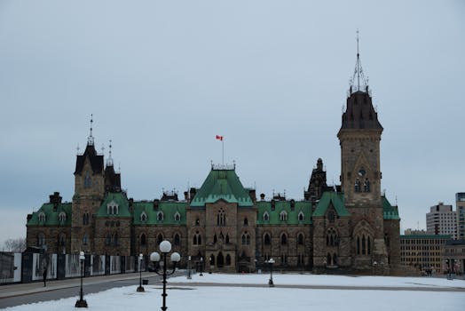 Historic East Block building in Ottawa with Gothic architecture and green roofs during winter.