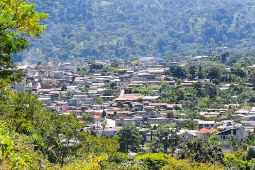 Captivating aerial view of a town surrounded by lush greenery in Ciudad de Guatemala, capturing the essence of local architecture.