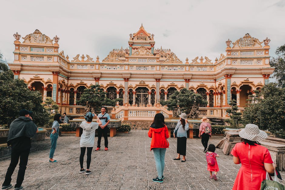 Visitors exploring the historic Vinh Trang Temple, a famous landmark in Vietnam.