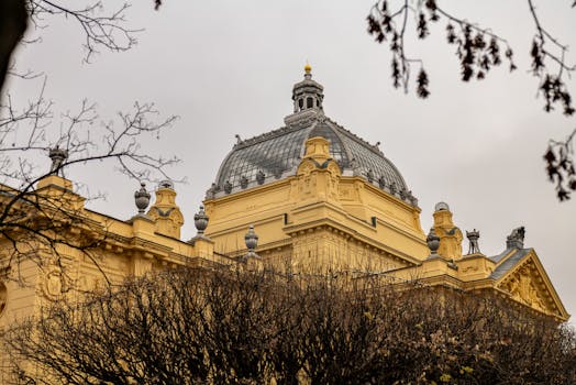 View of the ornate Art Pavilion in Zagreb, showcasing its historical architecture against a cloudy sky.