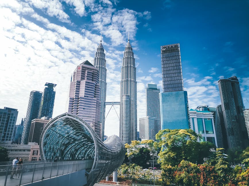 Stunning view of the iconic Petronas Towers and surrounding skyscrapers in Kuala Lumpur during the day.