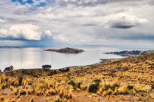Breathtaking landscape of Lake Titicaca with a view of distant islands under dramatic skies.