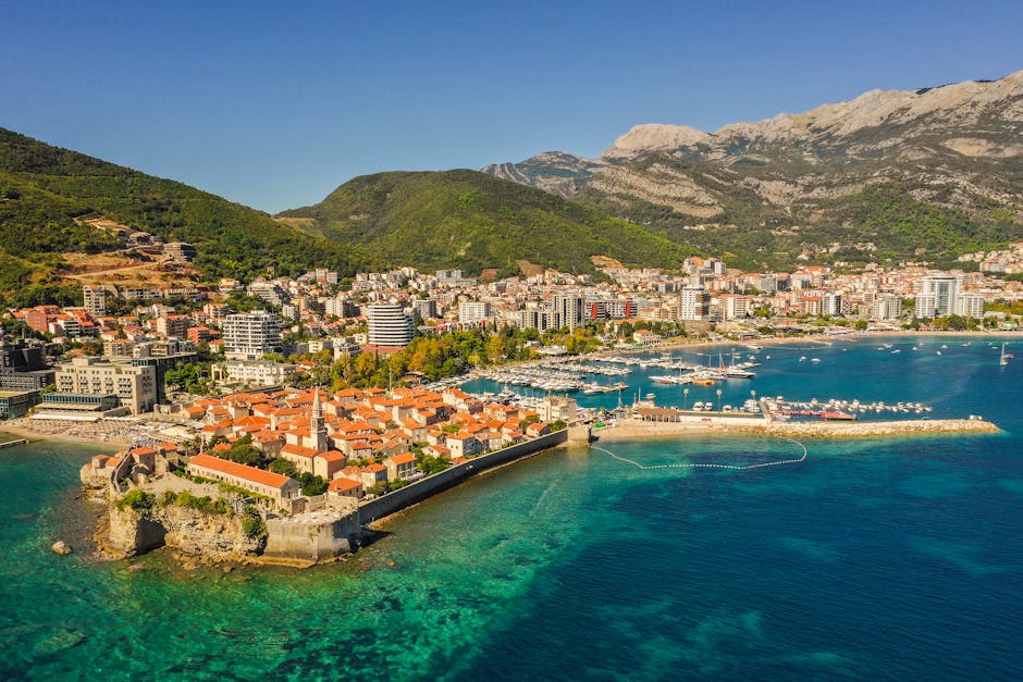 Explore Budva, Montenegro's stunning coastal cityscape, showcasing historic architecture and vibrant waterfront views.