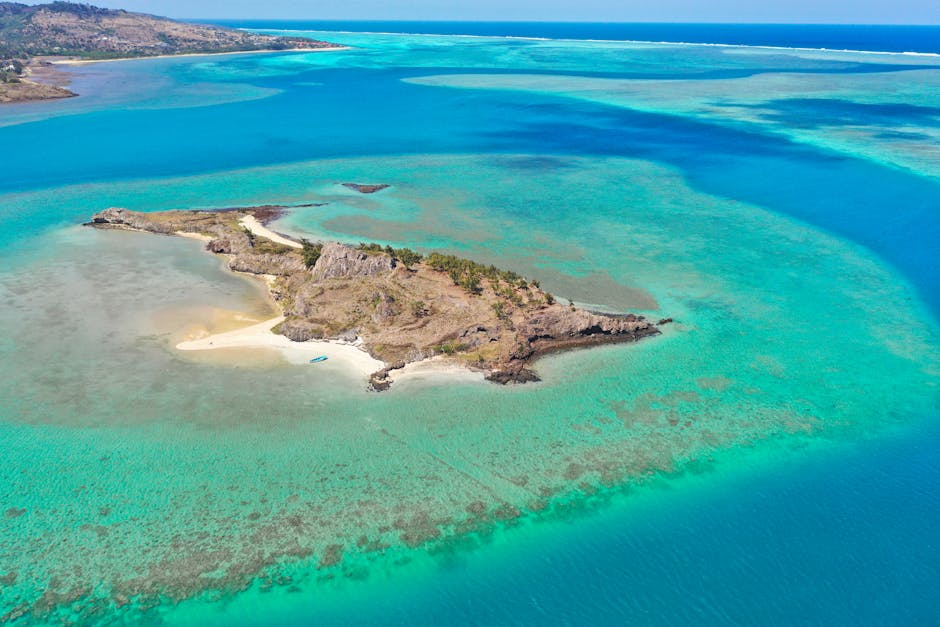 Stunning aerial shot of a serene island surrounded by turquoise waters in Mauritius.