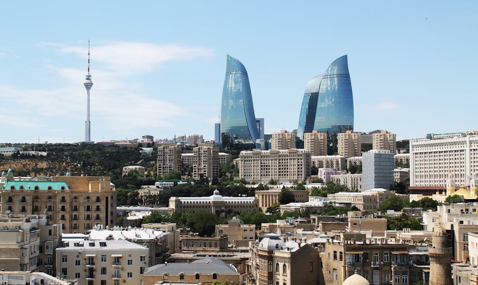 Stunning aerial cityscape of Baku featuring the iconic Flame Towers under a clear blue sky.