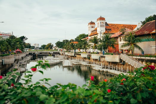 Charming riverside scene featuring historic colonial architecture and vibrant greenery.