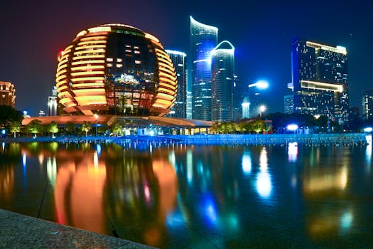 Stunning reflection of Hangzhou's illuminated skyline featuring modern architecture during the night.