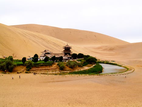 A stunning vista of Crescent Lake surrounded by Mingsha Sand Dunes in Dunhuang, China.