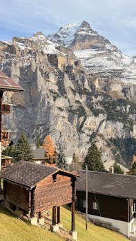 Picturesque Lauterbrunnen village with Swiss Alps in the background, showcasing stunning mountain scenery.