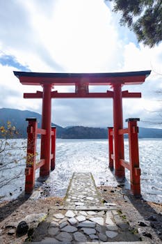 Scenic view of Hakone Shrine Torii Gate with Lake Ashi in the background, capturing Japan's natural beauty.