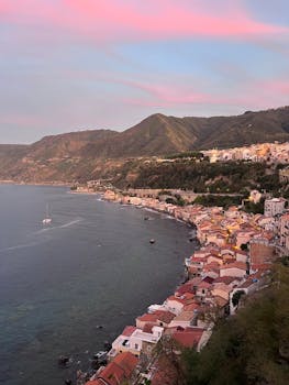 Beautiful coastal view of Scilla, Calabria, Italy during sunset with pink skies.