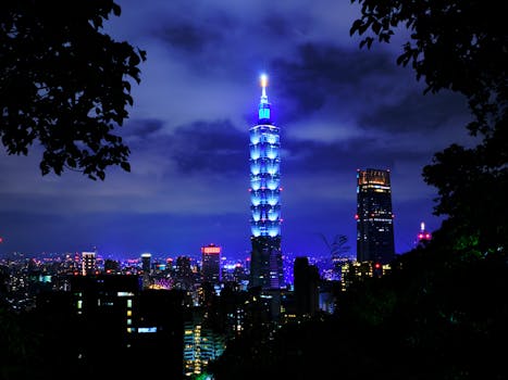 Stunning night cityscape of Taipei skyline featuring the illuminated Taipei 101 tower.