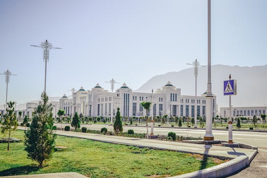 Elegant white government building with ornate lamp posts in Ashgabat.