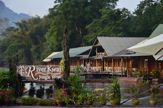 Capture tranquility at the River Kwai Jungle View in Thailand. Perfect riverside escape amidst lush greenery.